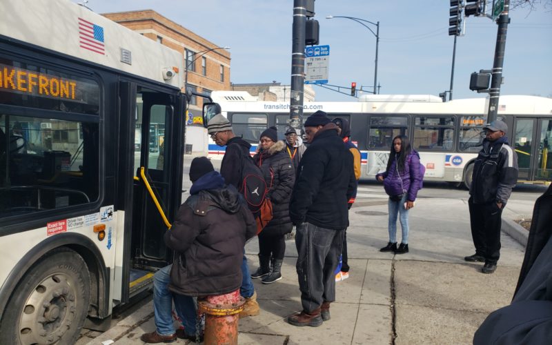 Riders wait to board the 79 bus on Chicago's South Side