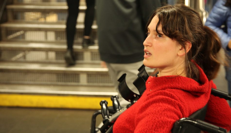 Woman in red shirt in a wheelchair at the Whitney