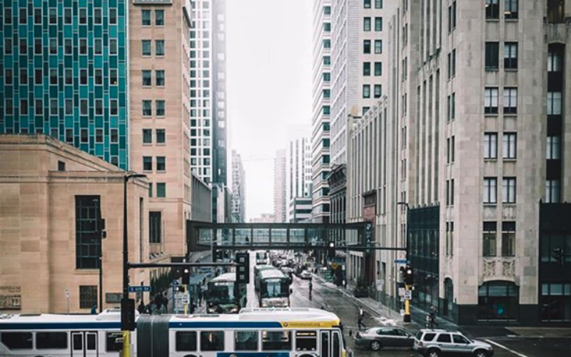 A bus crosses an intersection in downtown Minneapolis. Photo Credit: Tyler James (@firsthandaccount)