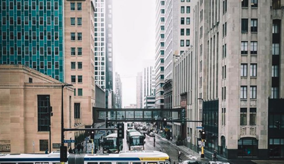 A bus crosses an intersection in downtown Minneapolis. Photo Credit: Tyler James (@firsthandaccount)